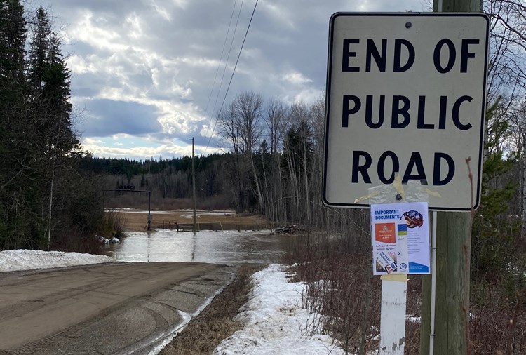 A sign on Upper Mud River Road stands near a flooded section of road. Access in the area remains a concern for the Regional District of Fraser-Fort George, which prompting an evacuation order.