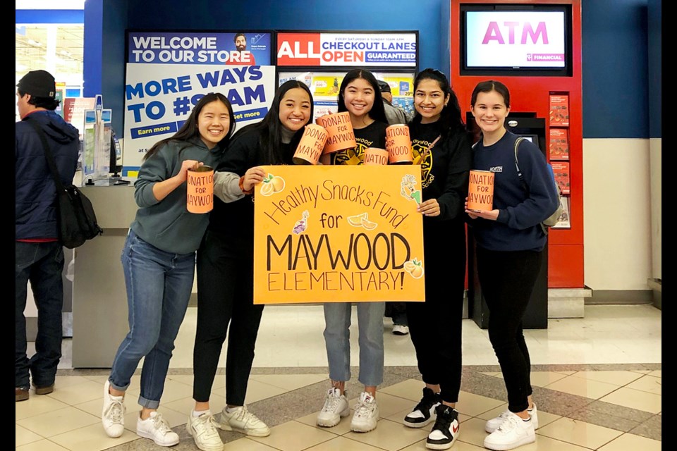 Burnaby North Secondary School Grade 12 students Haley Ham, Elizabeth Chung, Megan Wong, Avneet Minhas and Cassandra Sacilotto pose for a photo at the entrance of the Metrotown Superstore, where they bagged groceries to fundraise for healthy snacks for local elementary school kids.
