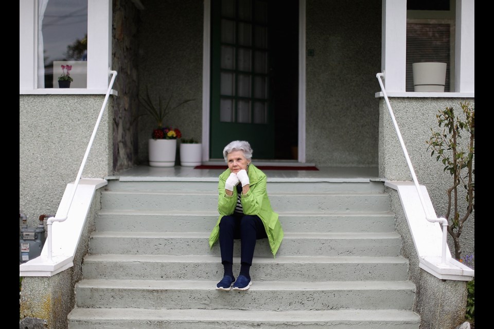 Dee Van Straaten, 75, sits on the front steps of her rental home for nearly three decades on Wildwood Avenue in Victoria.s She&Otilde;s one of many tenants who are facing eviction, despite measures to protect renters during the COVID-19 crisis