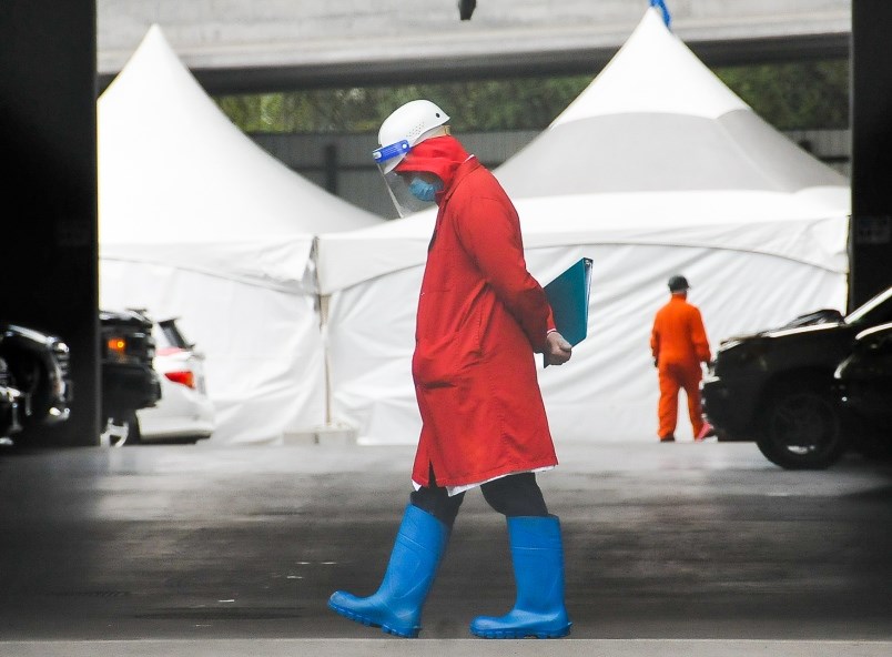 An employee at the Superior Poultry Processors Ltd. mans the gate April 23 with a infrared thermomet