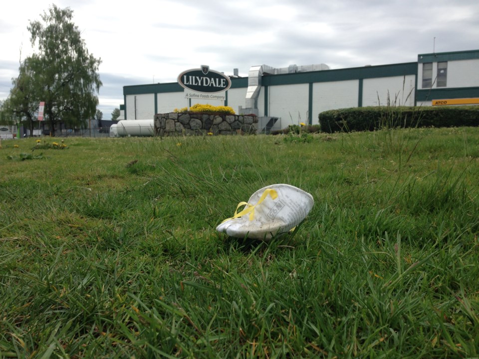 A medical mask discarded outside the Lilydale poultry processing plant run by Sofina Foods Inc. One