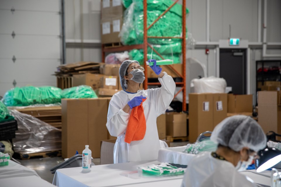 Workers make face shields at Surrey’s Firetech Manufacturing. | City of Surrey