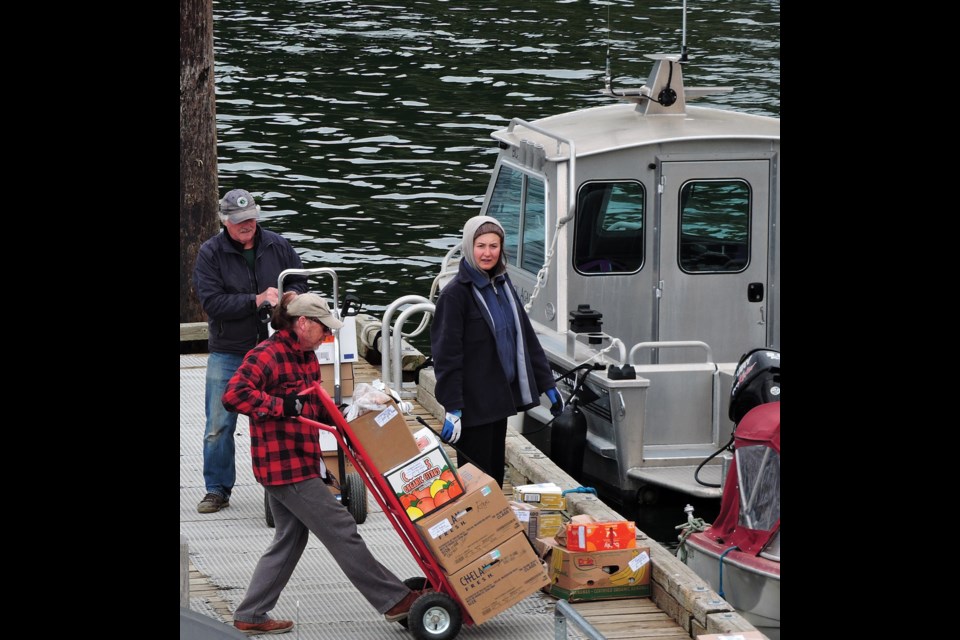 Gambier residents Terry Hall, Bobby Bruce and Estelle Honeywell sort orders, April 20.