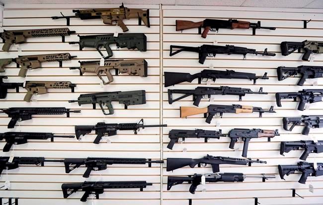 In this Oct. 2, 2018, semi-automatic rifles fill a wall at a gun shop in Lynnwood, Wash. Starting Tuesday, Jan. 1, 2019. The federal government is poised to ban a variety of assault-style rifles. THE CANADIAN PRESS/AP-Elaine Thompson