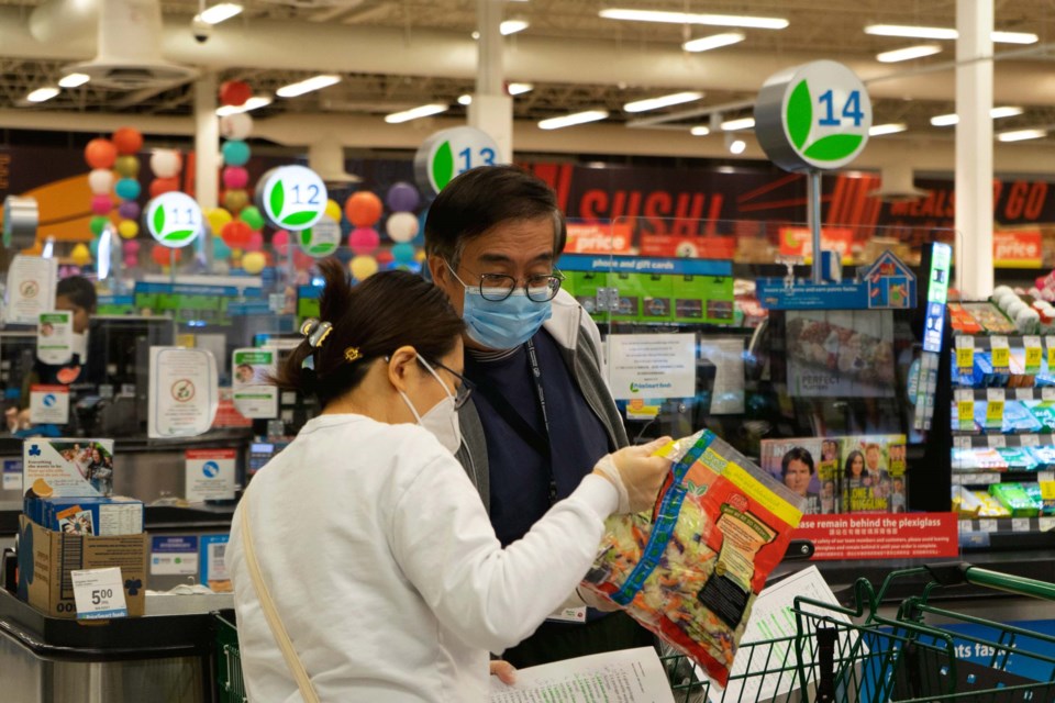 RCRG volunteers spend their evenings gathering groceries for isolated seniors in Richmond. Ray Wang photos