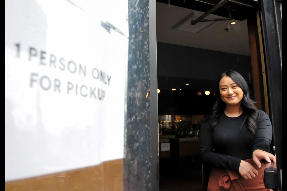 In a restaurant that would once serve dozens of customers at a time, now pick-up orders are delivered one person at a time.