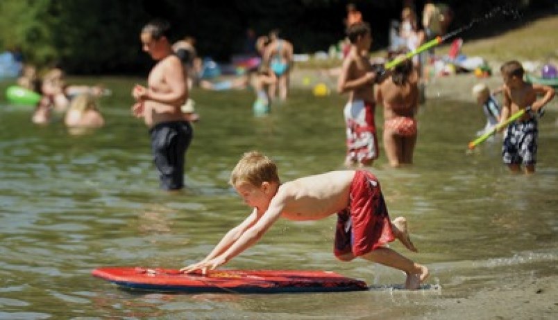 Boy swimming at White Pine beach in Belcarra Regional Park