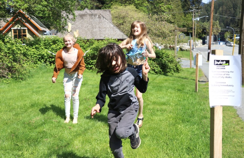 Kids silly walking toward a sign