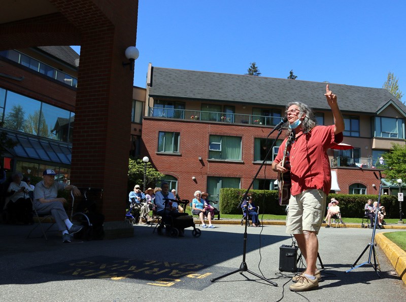 Chris Ridout teaches yoga and conducts a sing-a-long at Parkwood Manor in Coquitlam last Thursday.