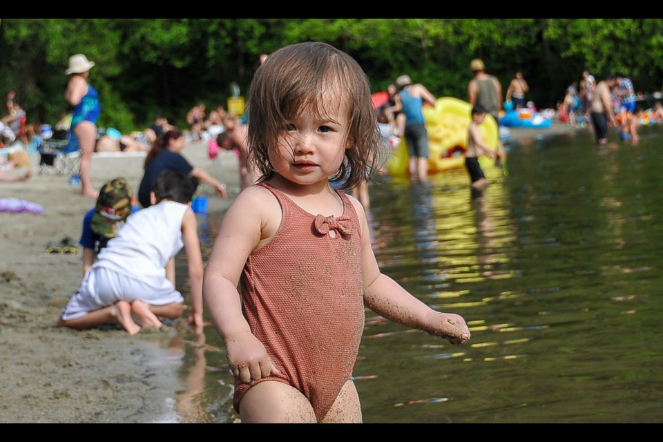 Eloise Chan plays in the sand with her father Chris at Belcarra Regional Park's White Pine beach