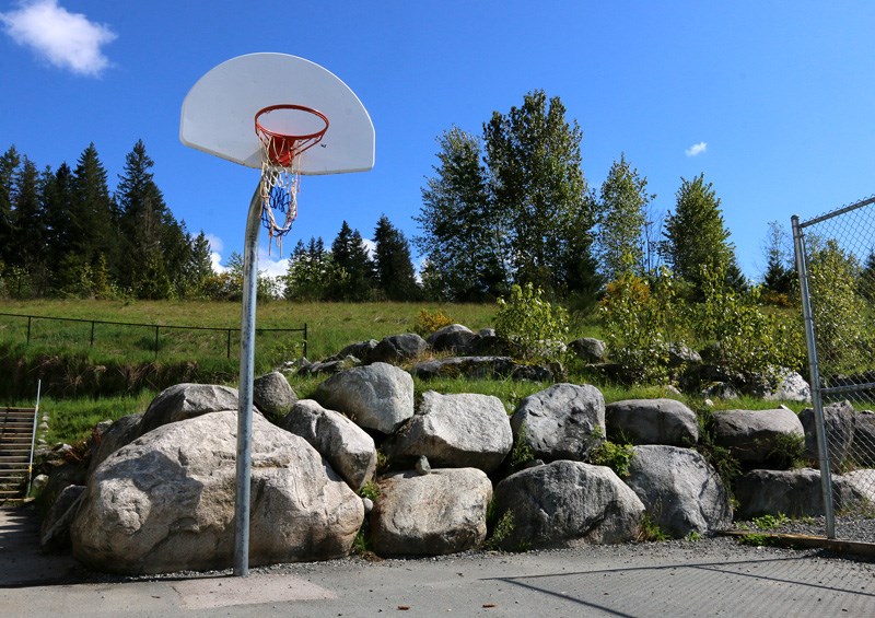 The fences closing off a basketball court and hillside next to Eagle Mountain middle school are down, but the problem of water contaminated with e coli and fecal coliform from a failed septic system above the school persists.