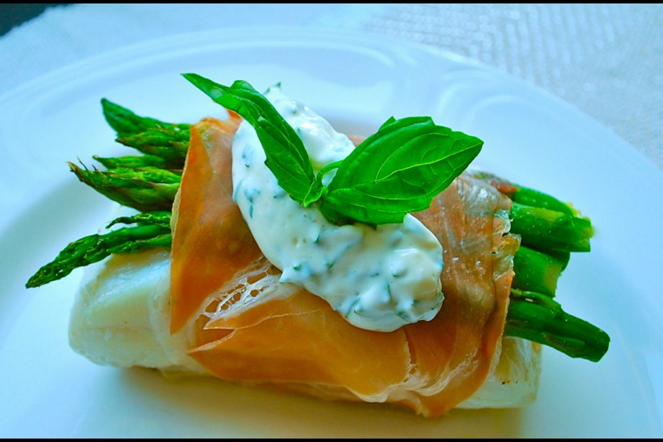 Baked B.C. halibut and asparagus tastily wrapped in prosciutto.