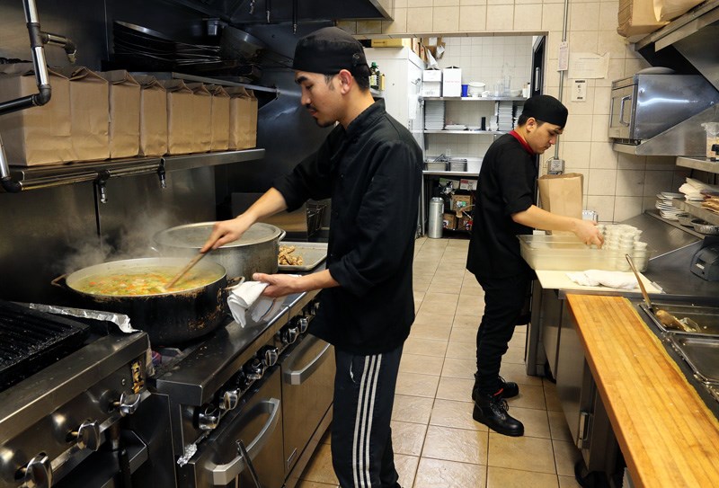 Siawash Noori and Suliman cook up a storm at their family's Mediterranean restaurant in Port Coquitlam as they prepare about 400 meals for front line health care workers at Eagle Ridge Hospital.