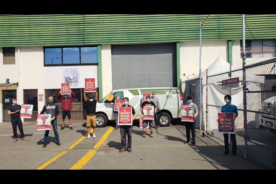 The Scene Ideas staff with the signs, with part proceeds going to a children's charity. Photo submitted