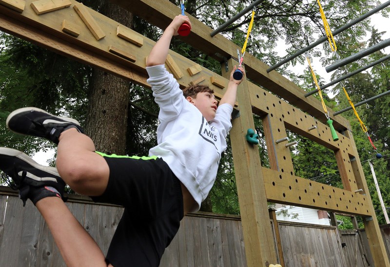 MARIO BARTEL/THE TRI-CITY NEWS When Rory Jago tells his friends he's just been hanging out in his backyard during the pandemic, he isn't kidding. The competitive Ninja warrior is able to keep up his training in the gym his dad, Mitch, built in the backyard of their Port Coquitlam home.