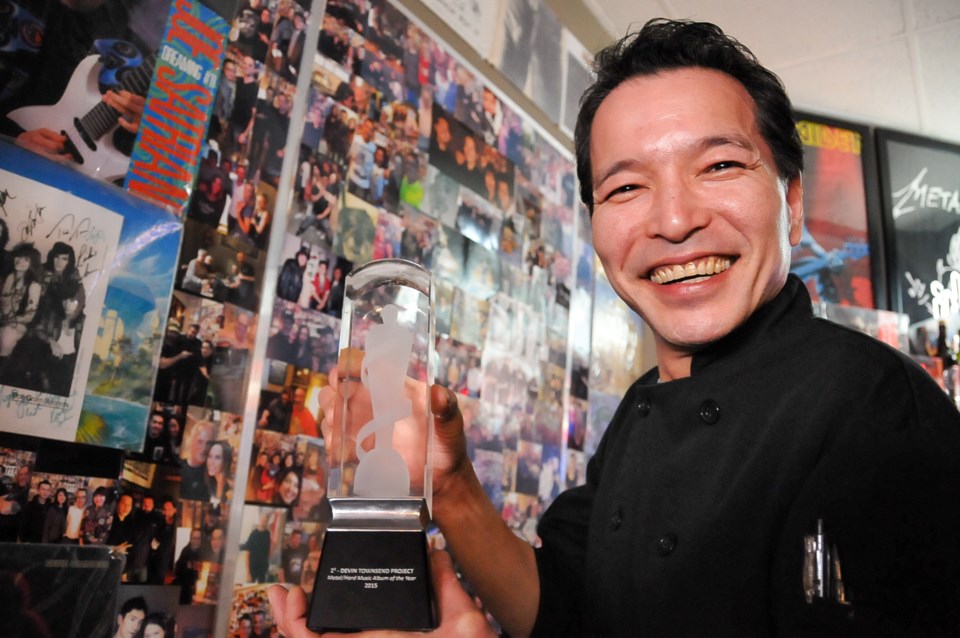 Keith Kamizato displays a Juno trophy for Heavy Metal Album of the Year, awarded to his childhood fr
