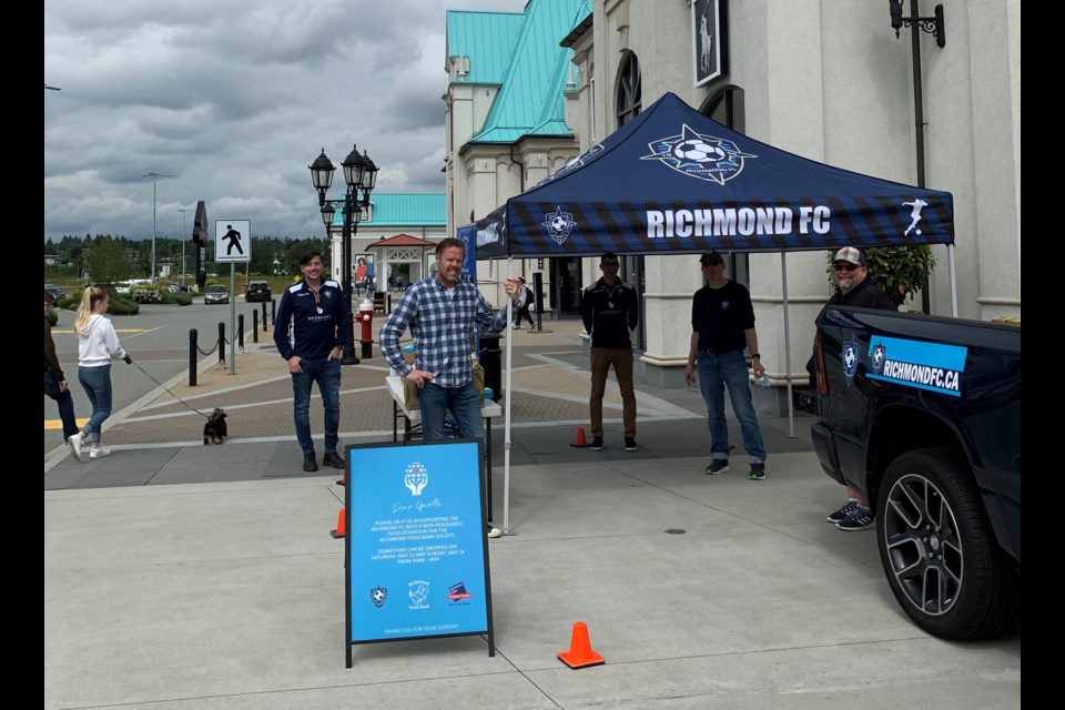 The Richmond FC team gets set up for the food bank drive at McArthurGlen on the weekend. Photo submitted