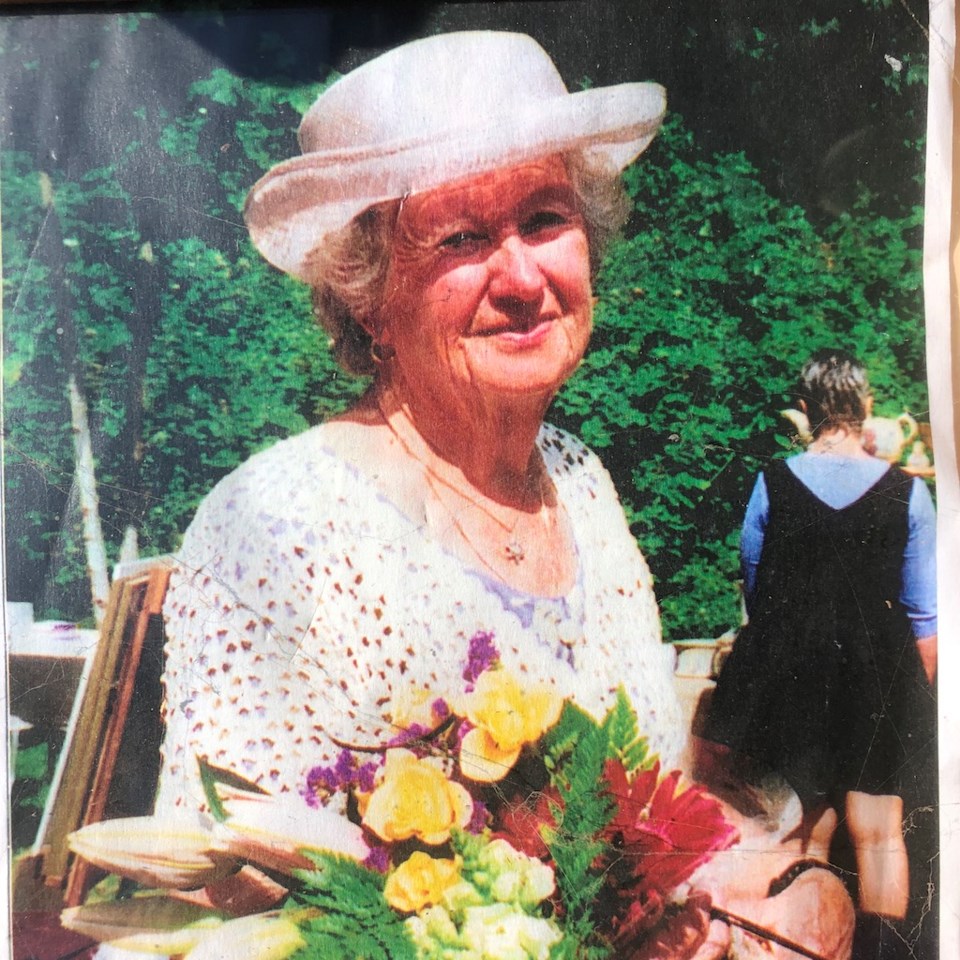 Joan Knight holding a bouquet of flowers