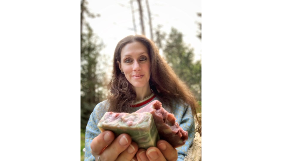 Helen holding soap out to the camera