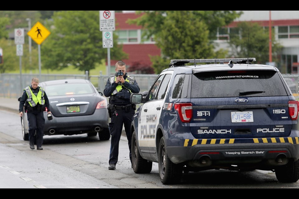 Saanich police constables Chelsea Cofield and Curtis Craig check for speeding motorists near Marigold Elementary and Spectrum Community School on Tuesday.