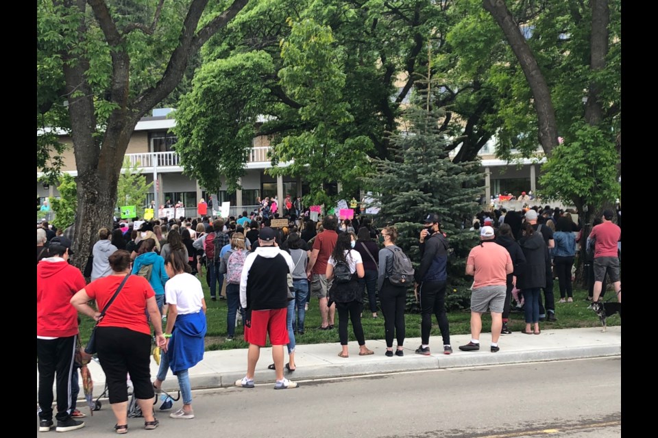 People gather at a Black Lives Matter rally on the lawn of city hall on Friday.