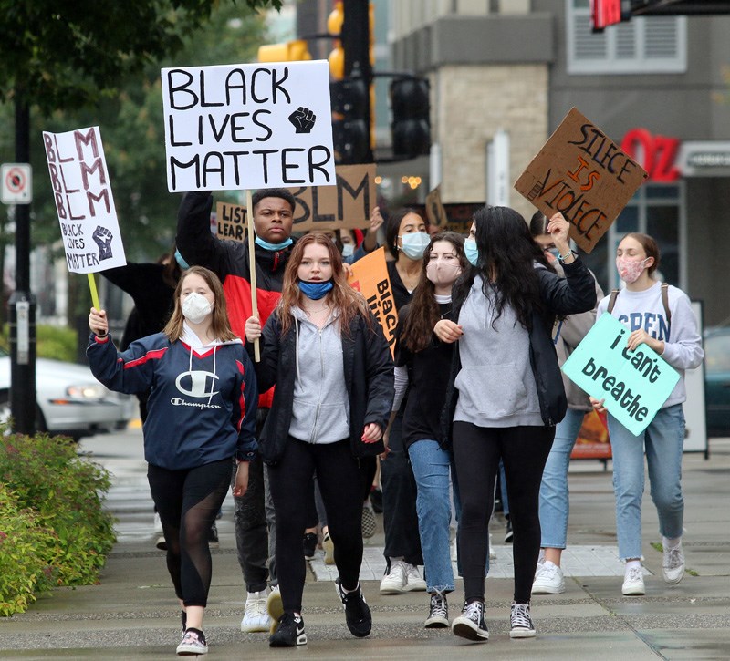 MARIO BARTEL/THE TRI-CITY NEWS A group of about 20 high school students protesting racism march up
