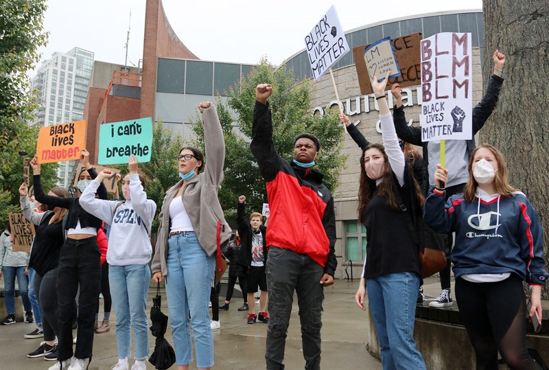 A group of about 20 high school students protesting racism rally in front of Coquitlam city hall on Tuesday after marching from downtown Port Coquitlam.