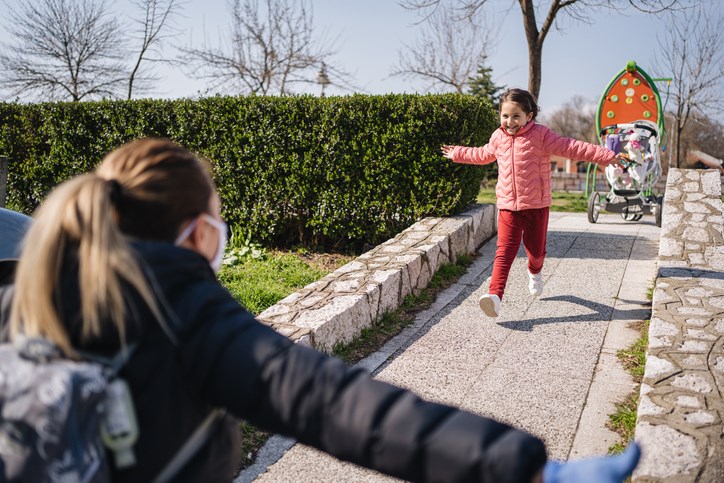 A child greets a family member after returning from a hospital due to a COVID-19 infection.