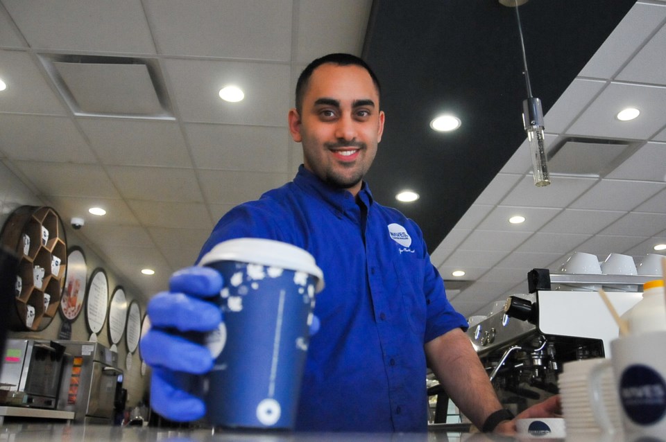 Kareem Adli, 23, helps run the Waves Coffee House off Westwood Street and Lougheed Highway, putting