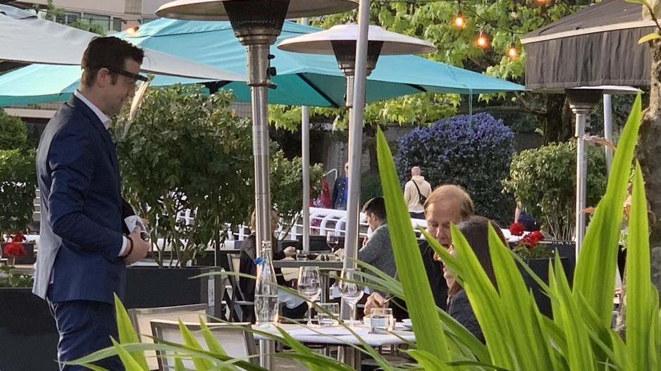 A server at Ancora restaurant wears a face shield to prevent the spread of COVID-19