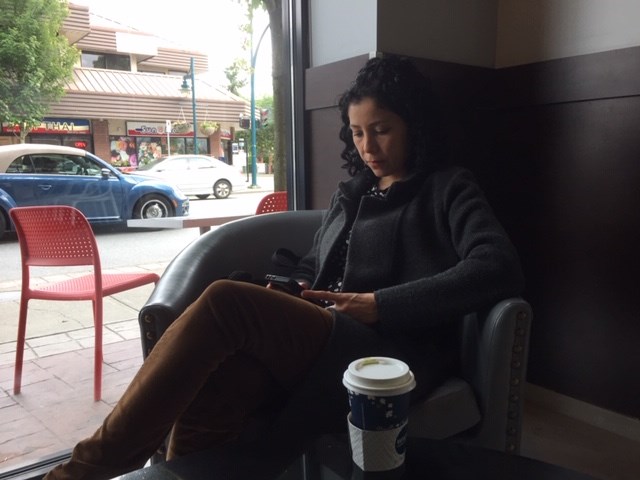 Melissa Gaitan relaxes in a corner at Waves Coffee House