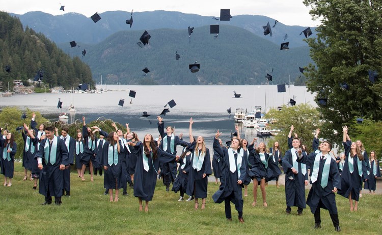 Graduating students from Seycove Secondary toss their caps during a physically distanced graduation photo-op June 3. Graduating students all over the world are celebrating in different ways due to the COVID-19 pandemic. photo The Canadian Press/Jonathan Hayward