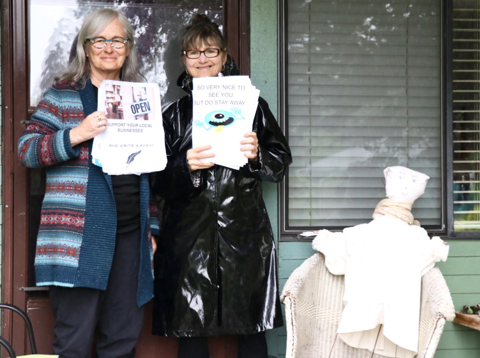 Women holding a stack of signs