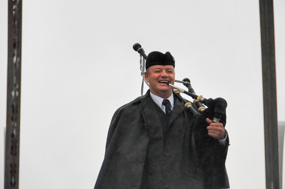 Chisholm embraces the dreary weather while playing a 'Lament to the Highland Games,' Saturday, June