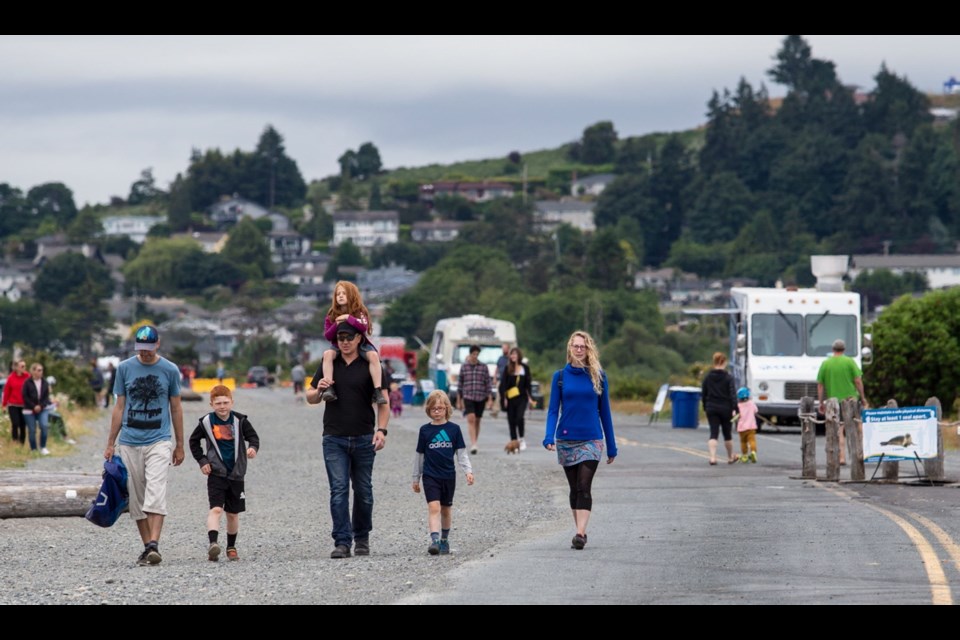 Families walk on Ocean Boulevard during a recent Beach Food, where food trucks set up on the closed portion of the road through Esquimalt Lagoon.