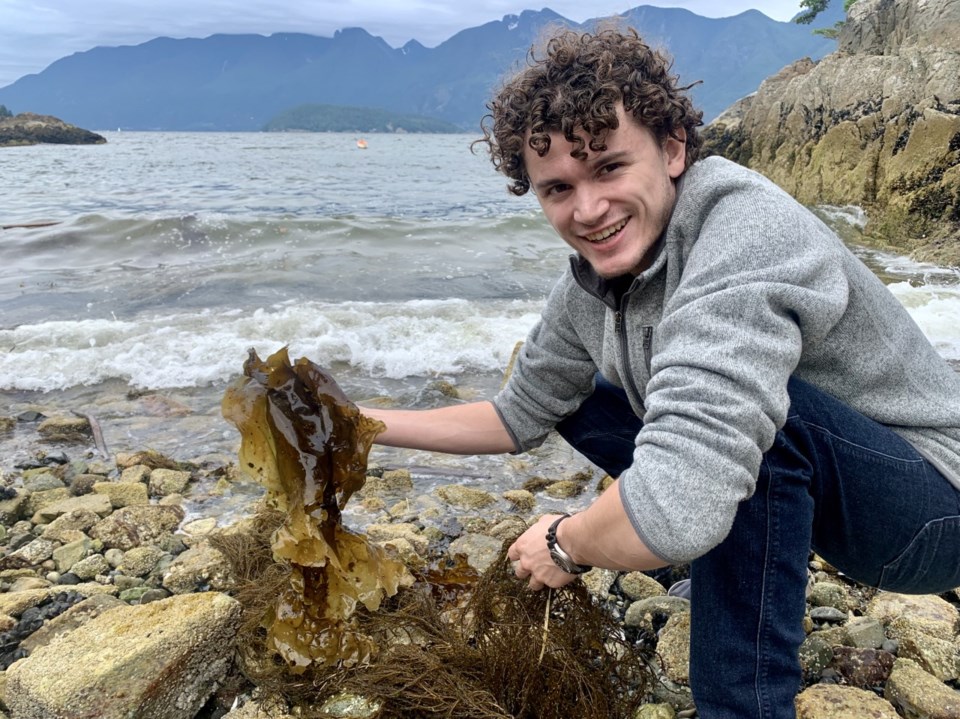 Tobin Sparling holding up seaweed