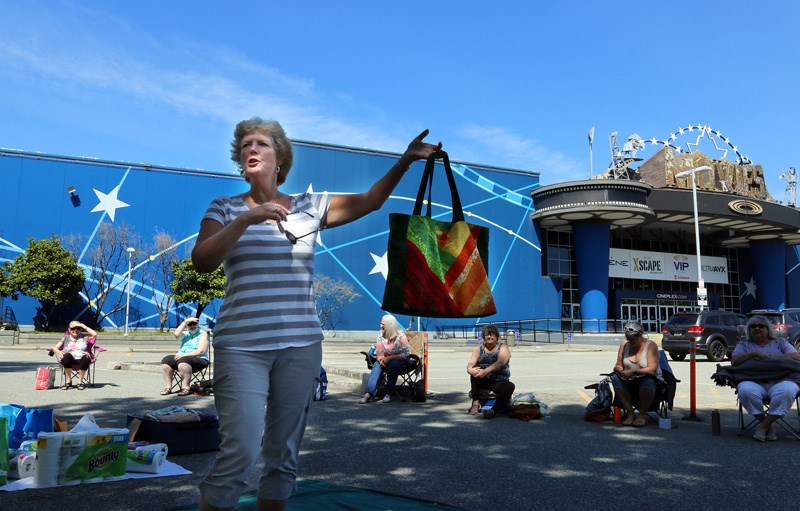 MARIO BARTEL/THE TRI-CITY NEWS Sharon Wylie shows off the bag she quilted at the weekly outdoor meeting of the Blue Mountain Quilters Society.