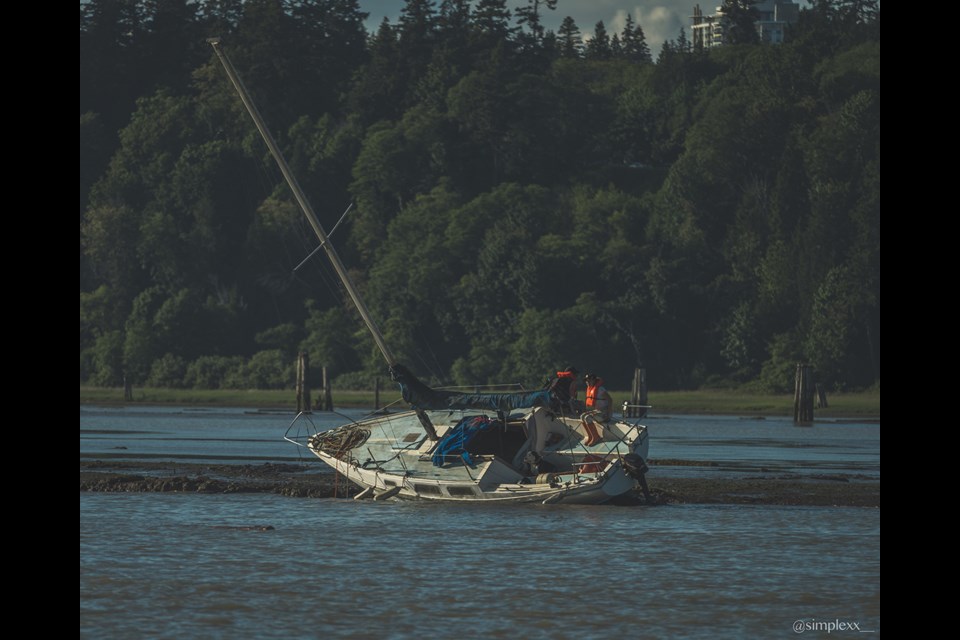 Richmond resident Justin Lee and his friends called the coast guard when they came across two people stranded on a sailboat, which ran aground near Iona Beach.