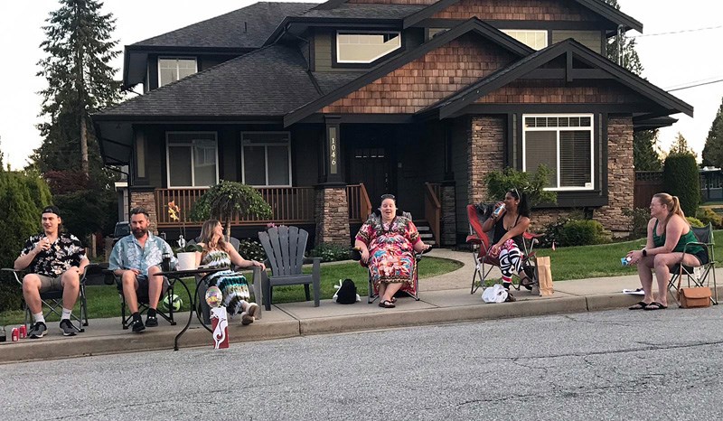These Grover Avenue neighbours gather for their nightly discussion over beverages, a tradition that started March 15.
