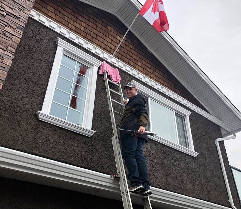 Craig Slack puts up a Canadian flag
