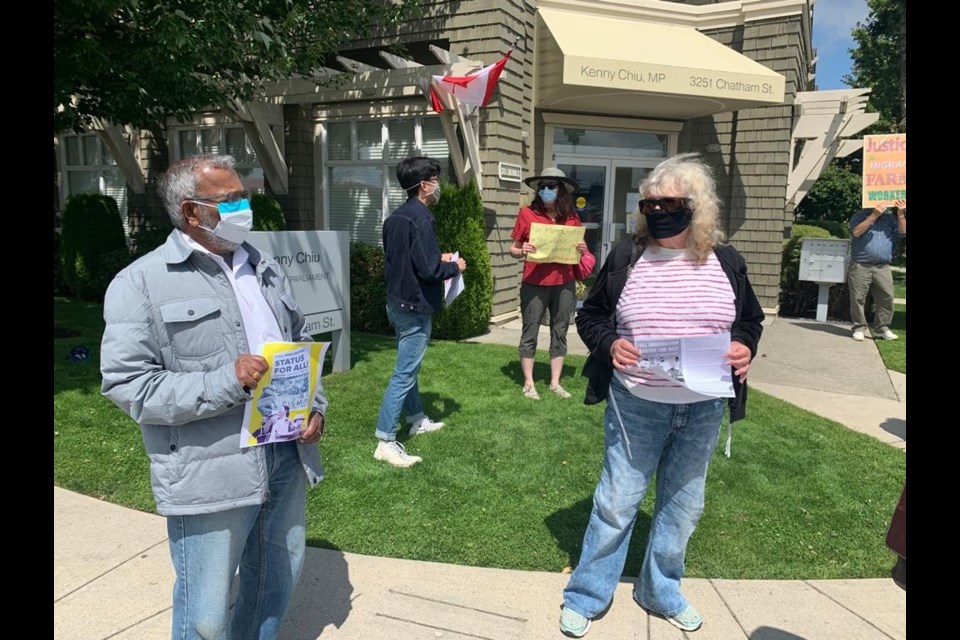 Protesters gathered outside Steveston-Richmond East MP Kenny Chiu's office calling for equal rights for migrant workers.