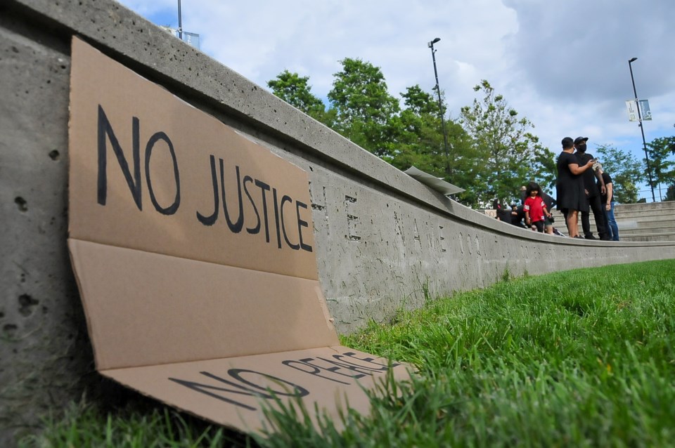 A poster left after a Black Lives Matter rally at Town Centre Park in Coquitlam, July 4, 2020.