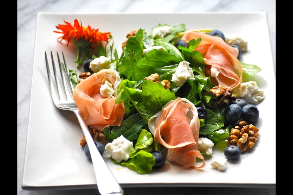 This summer salad is adorned with prosciutto, blueberries, tangy cheese and walnuts.