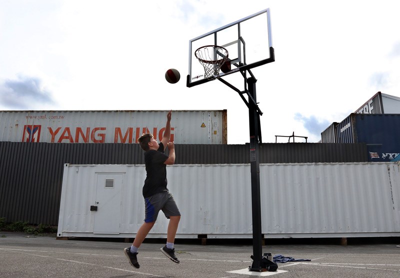 MARIO BARTEL/THE TRI-CITY NEWS A player at one of the Panther Hoops basketball camps goes for a layup on makeshift courts prepared by parent volunteers in the back parking lot of BC Christian Academy in Coquitlam.