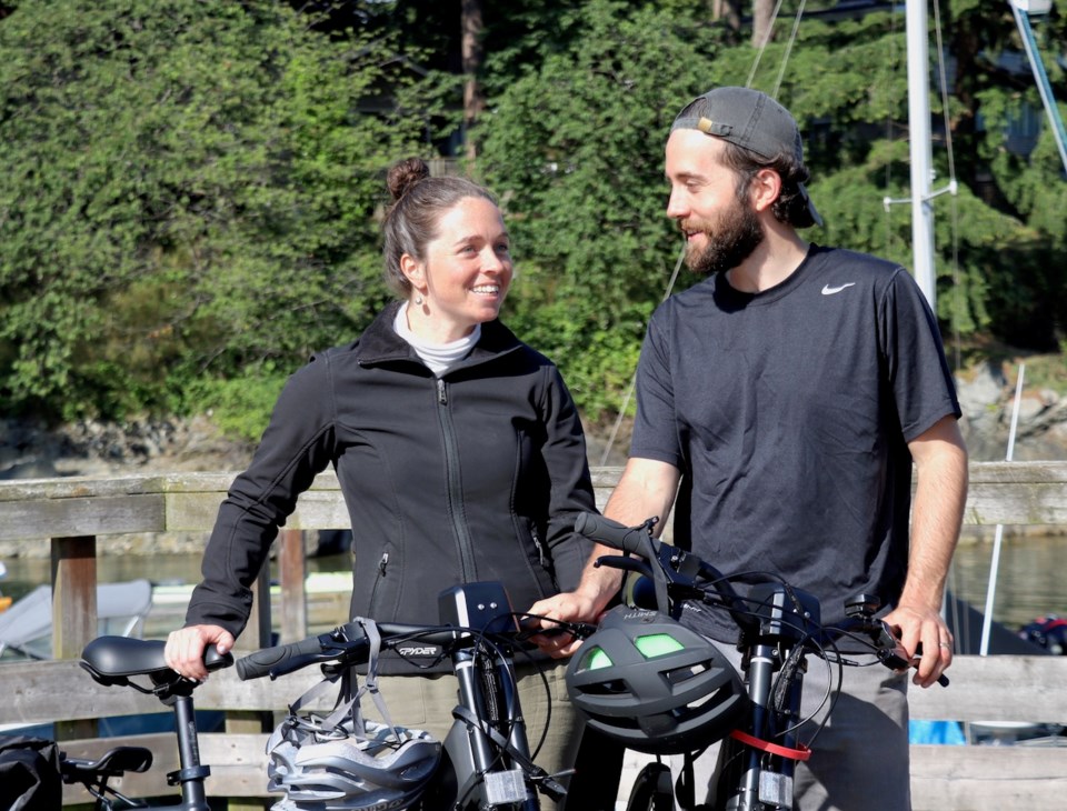 Two people standing with bike