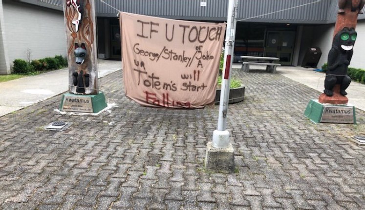 RCMP are investigating after a sign was strung up between the welcome poles at Pender Harbour Elementary-Secondary School.