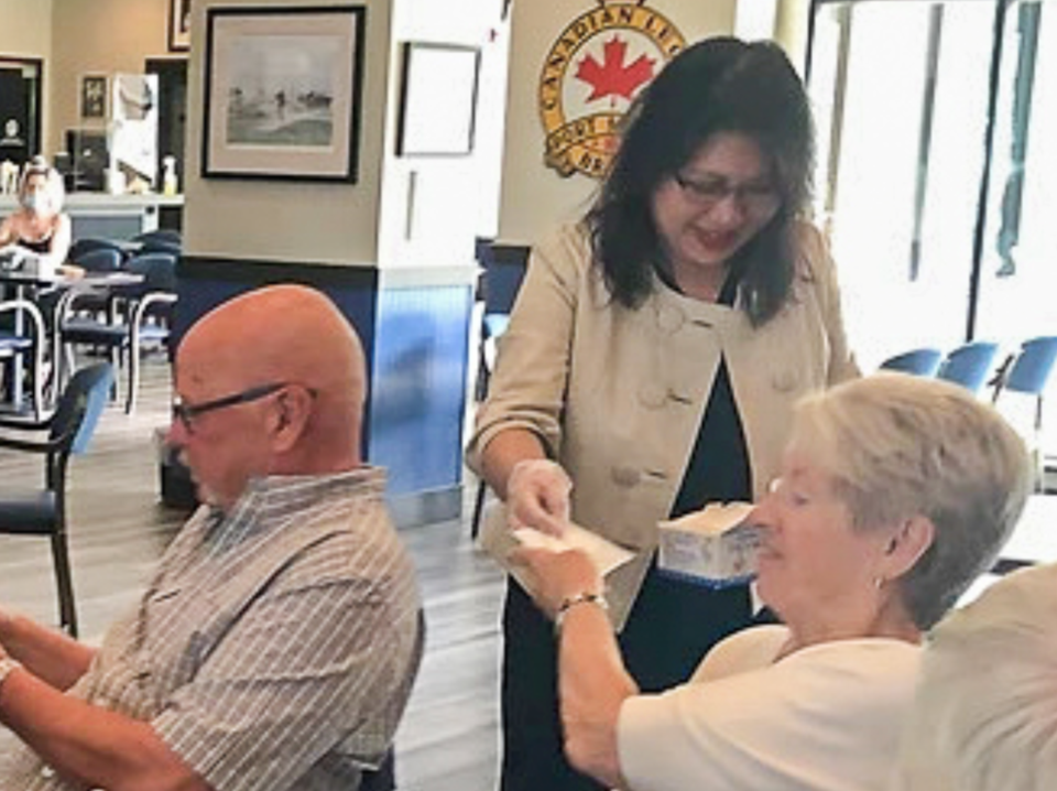 A mask-less Nelly Shin, Conservative MP for Port Moody-Coquitlam, interacts with seniors at the Port