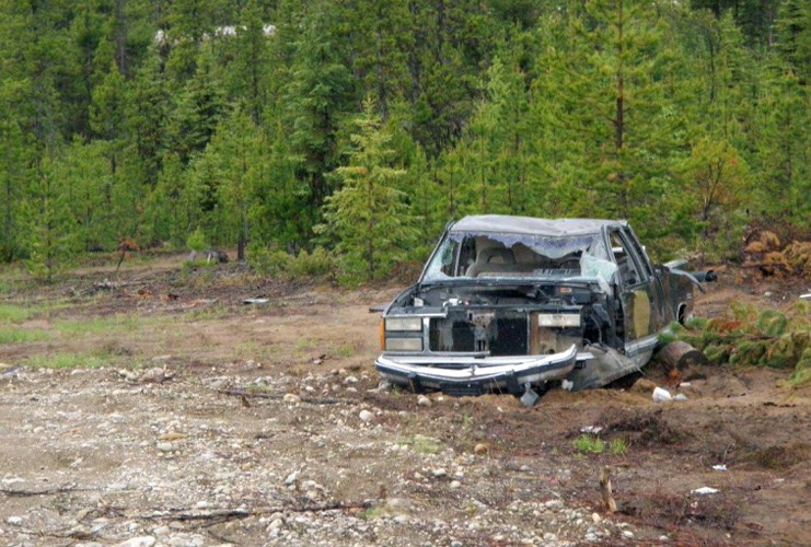 An abandoned car is seen on a pair of undeveloped lots in Bear Lake, in this Regional District of Fraser-Fort George handout photo.