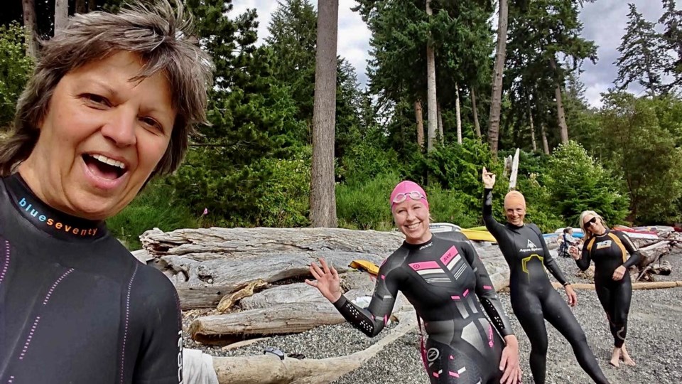 Four women in wetsuits