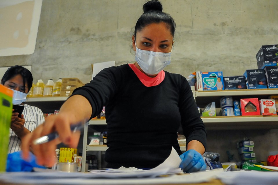 Gabi Solano, a refugee who herself is waiting for a decision on her case, organizes lists of address